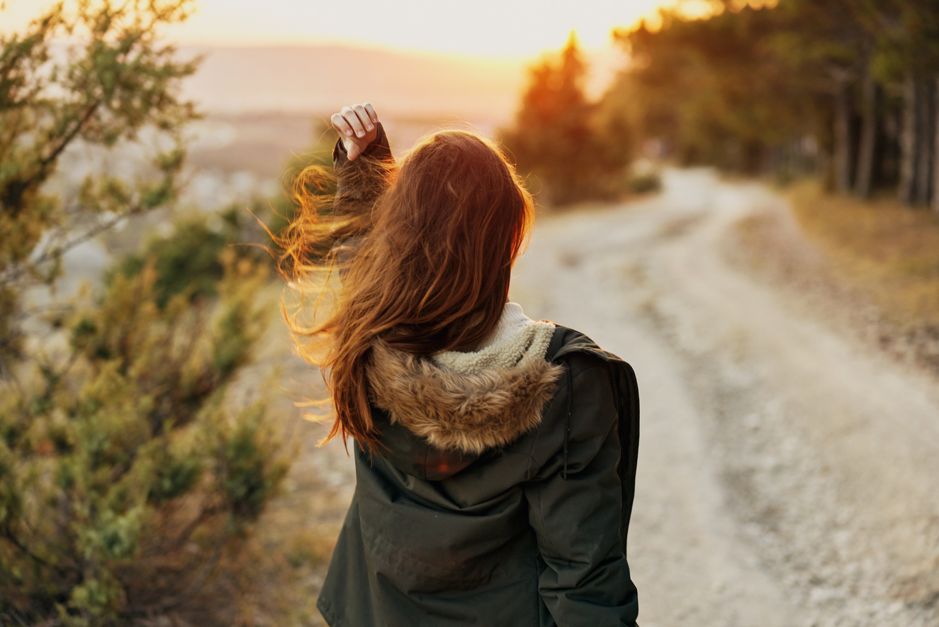 Woman in Autumn Jackets on Nature Road Walk Back View