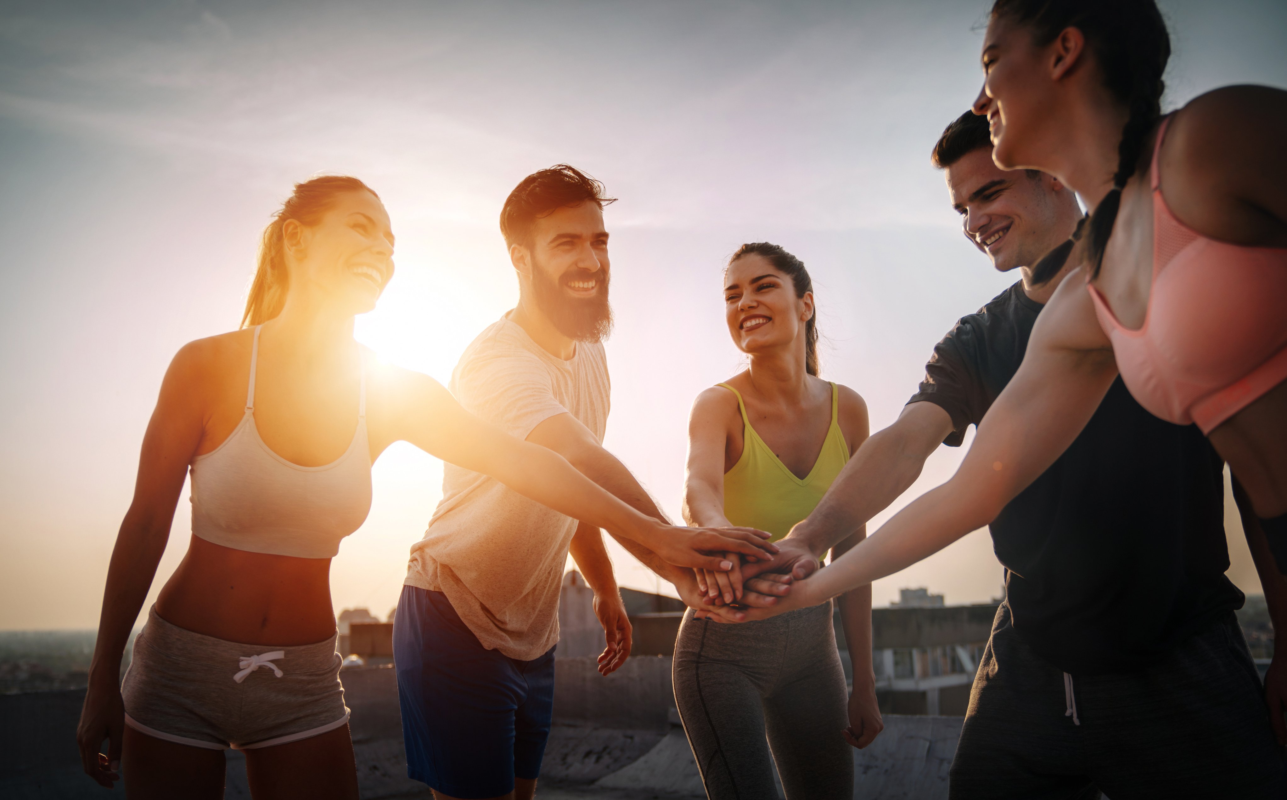 Group of fit healthy friends, people exercising together outdoor